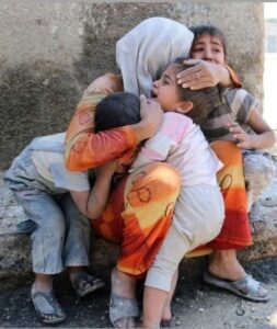 A Woman Hugging Crying Kids
